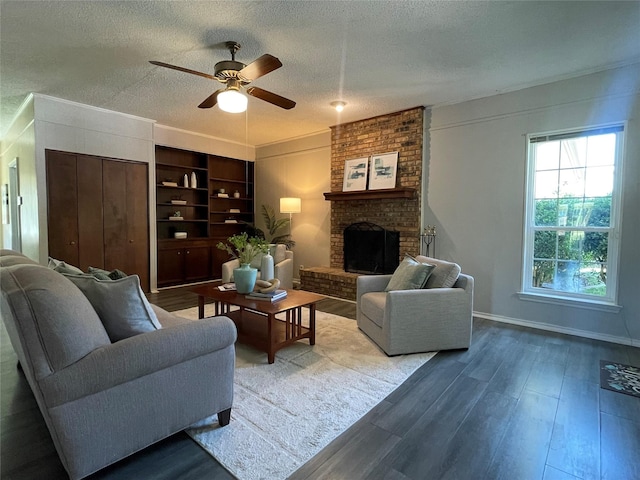 1610 Newsom Ct, Pantego, TX 76013 - living room featuring a ceiling fan, wood finished floors, a brick fireplace, and a textured ceiling