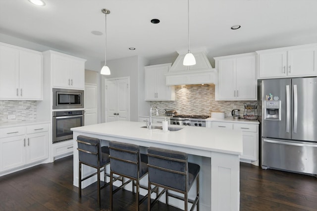 1617 Commons Way, Prosper, TX 75078 - kitchen with appliances with stainless steel finishes, tasteful backsplash, a kitchen bar, dark wood-type flooring, and recessed lighting