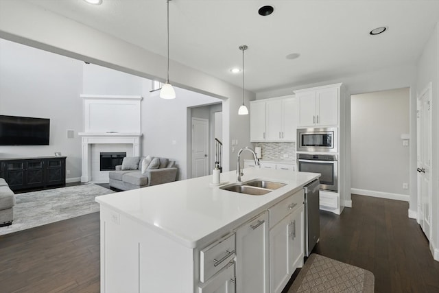 1617 Commons Way, Prosper, TX 75078 - kitchen with stainless steel appliances, backsplash, white cabinets, dark wood finished floors, and light countertops