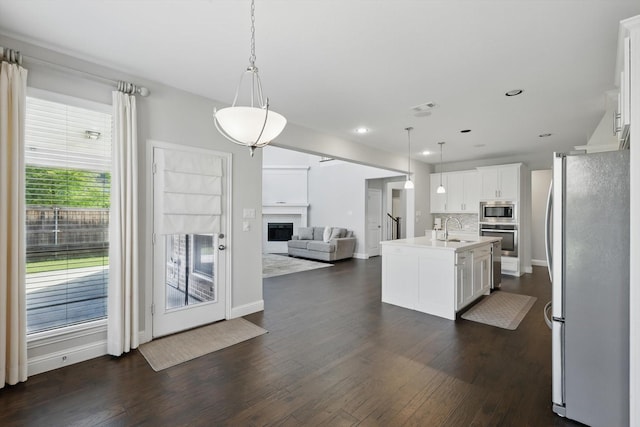 1617 Commons Way, Prosper, TX 75078 - kitchen featuring stainless steel appliances, open floor plan, white cabinetry, light countertops, and dark wood-style flooring