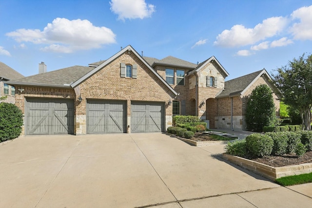 1617 Commons Way, Prosper, TX 75078 - view of front of property with brick siding, driveway, an attached garage, and roof with shingles