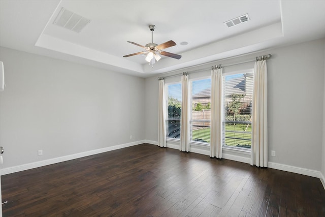 1617 Commons Way, Prosper, TX 75078 - unfurnished room featuring a raised ceiling, a ceiling fan, and dark wood-type flooring