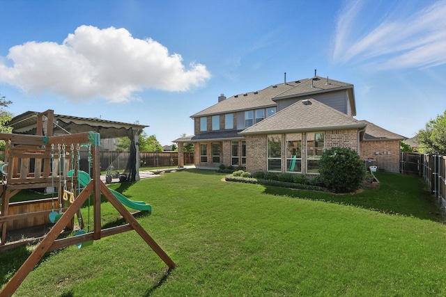 1617 Commons Way, Prosper, TX 75078 - back of house featuring a playground, a fenced backyard, brick siding, and roof with shingles