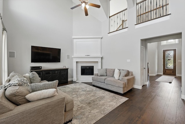 1617 Commons Way, Prosper, TX 75078 - living room with a towering ceiling, ceiling fan, dark wood finished floors, and a fireplace