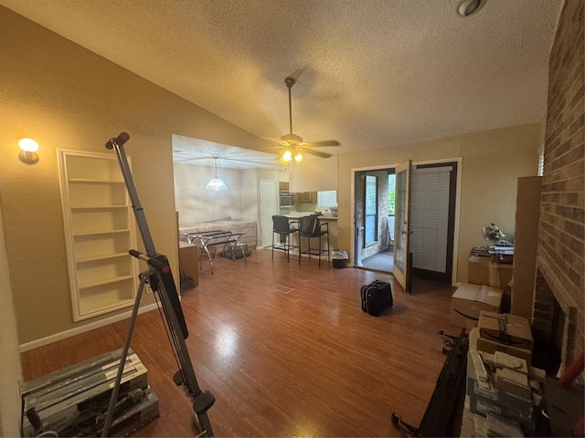 1909 Cloisters Dr Unit 1025, Arlington, TX 76011 - living room featuring a textured ceiling, wood finished floors, lofted ceiling, and a ceiling fan