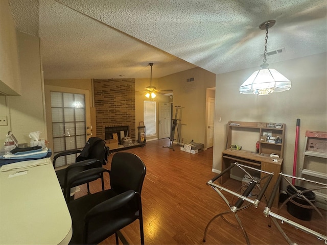 1909 Cloisters Dr Unit 1025, Arlington, TX 76011 - home office featuring wood finished floors, a ceiling fan, a textured ceiling, and a fireplace