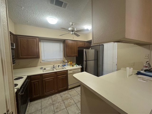 1909 Cloisters Dr Unit 1025, Arlington, TX 76011 - kitchen featuring range with electric cooktop, dishwasher, freestanding refrigerator, a textured ceiling, and ceiling fan