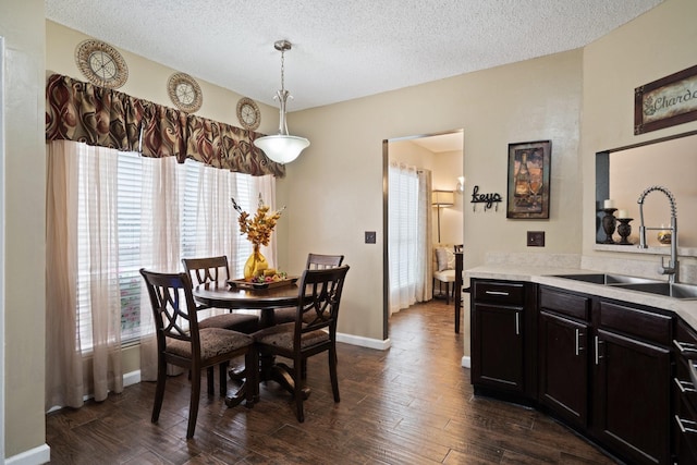 4443 Mercer St, Grand Prairie, TX 75052 - dining room featuring healthy amount of natural light, a textured ceiling, and dark wood-type flooring