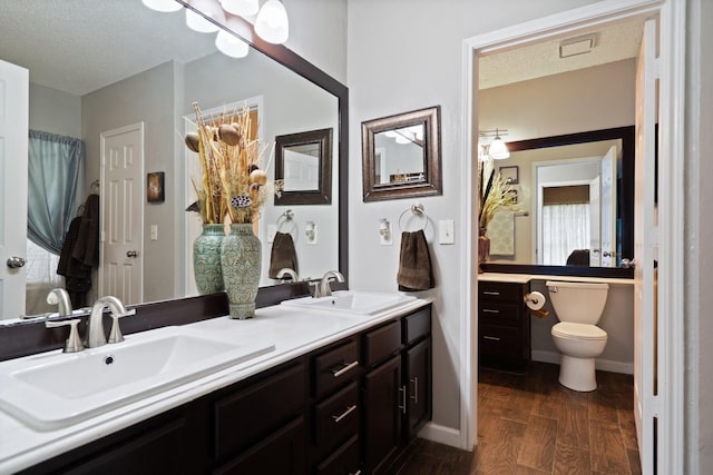 4443 Mercer St, Grand Prairie, TX 75052 - full bath featuring double vanity, wood finished floors, and a textured ceiling