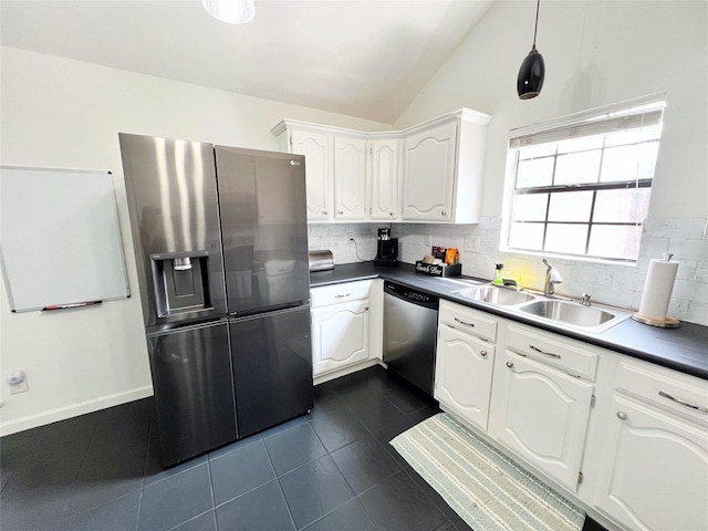 6828 Younger Dr, The Colony, TX 75056 - kitchen with appliances with stainless steel finishes, lofted ceiling, decorative backsplash, dark tile patterned floors, and white cabinetry