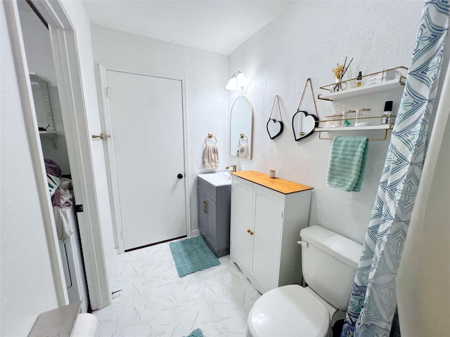 6828 Younger Dr, The Colony, TX 75056 - full bath featuring a textured wall, vanity, and marble finish flooring