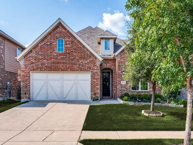 4141 Maclin Dr, Celina, TX 75009 - traditional home with brick siding, a front lawn, and driveway