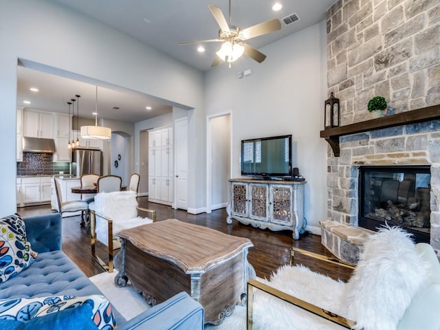 4141 Maclin Dr, Celina, TX 75009 - living room featuring ceiling fan, dark wood-type flooring, a fireplace, recessed lighting, and arched walkways