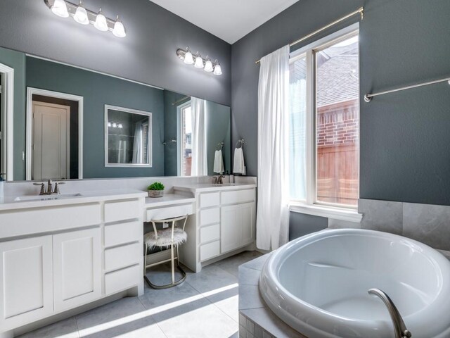 4141 Maclin Dr, Celina, TX 75009 - full bathroom with double vanity, a garden tub, and tile patterned floors