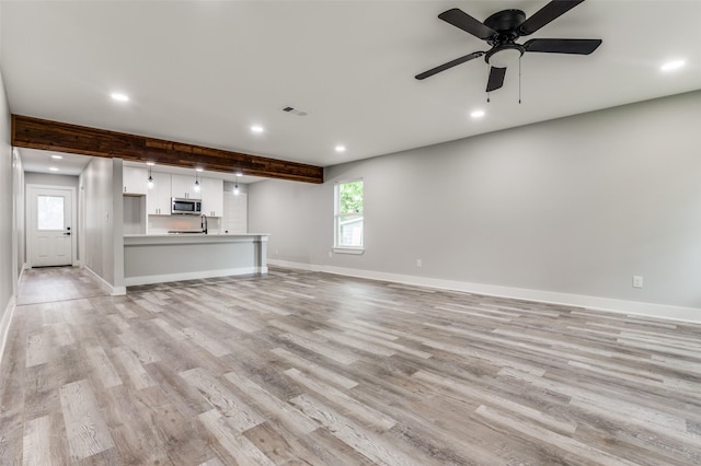 4131 Opal Ave, Dallas, TX 75216 - unfurnished living room featuring recessed lighting, light wood finished floors, beam ceiling, and a ceiling fan