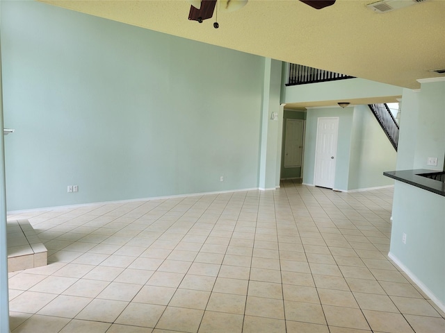 2001 Mark Twain Ln, Denton, TX 76210 - unfurnished room featuring ceiling fan, stairway, and light tile patterned flooring