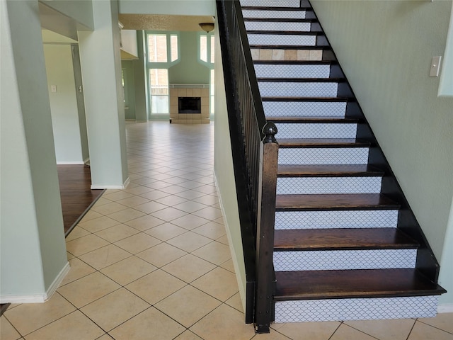 2001 Mark Twain Ln, Denton, TX 76210 - stairs featuring tile patterned floors and a tile fireplace