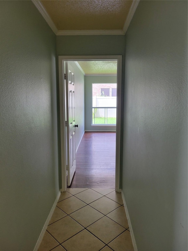 2001 Mark Twain Ln, Denton, TX 76210 - corridor featuring light tile patterned floors, crown molding, a textured ceiling, and a textured wall