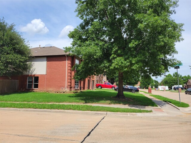 2001 Mark Twain Ln, Denton, TX 76210 - view of side of home with brick siding and a lawn