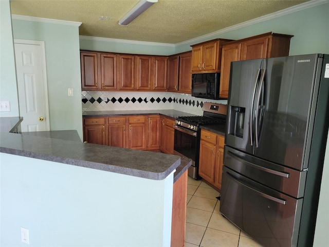 2001 Mark Twain Ln, Denton, TX 76210 - kitchen with refrigerator with ice dispenser, stainless steel gas range oven, black microwave, dark countertops, and tasteful backsplash
