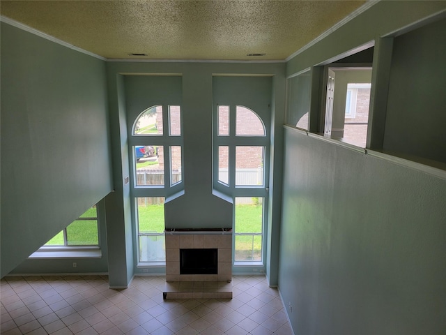 2001 Mark Twain Ln, Denton, TX 76210 - unfurnished living room featuring a textured ceiling, plenty of natural light, tile patterned floors, and crown molding