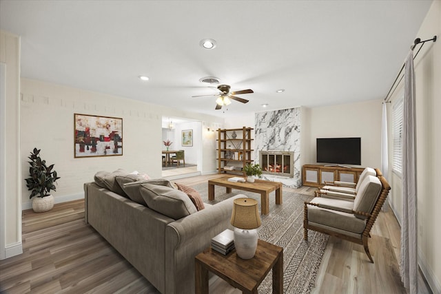 2207 English Dr, Garland, TX 75041 - living area with light wood-type flooring, recessed lighting, ceiling fan, and a fireplace