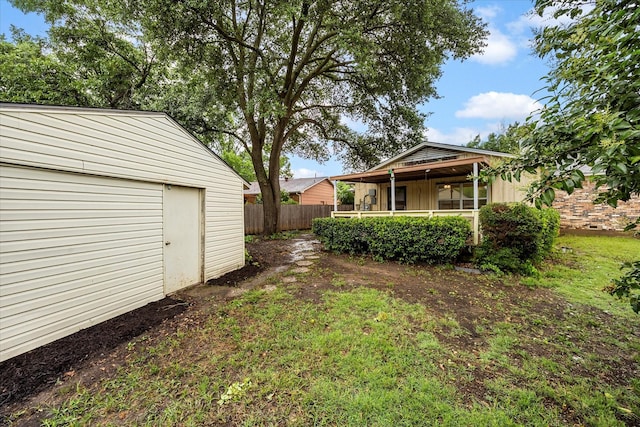 2207 English Dr, Garland, TX 75041 - view of yard featuring an outbuilding and covered porch