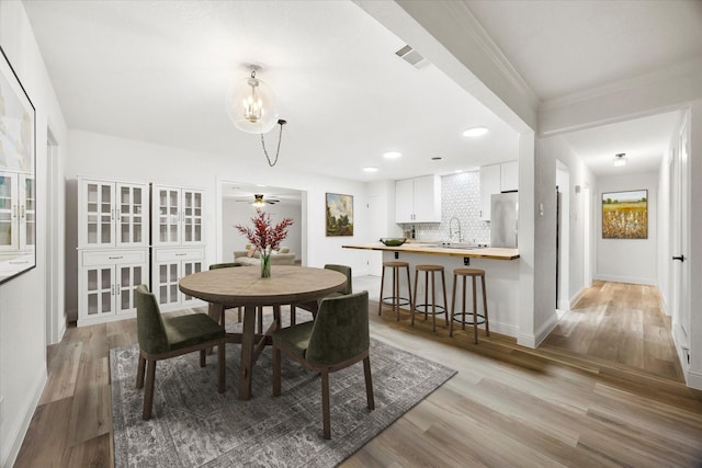 2207 English Dr, Garland, TX 75041 - dining space featuring light wood finished floors, a chandelier, crown molding, and recessed lighting