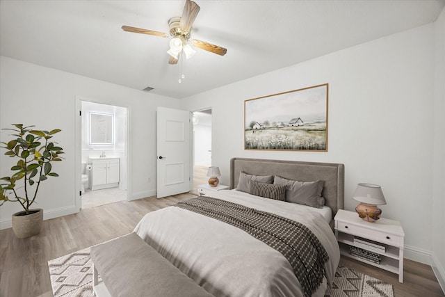 2207 English Dr, Garland, TX 75041 - bedroom featuring light wood-style floors, ensuite bathroom, and ceiling fan