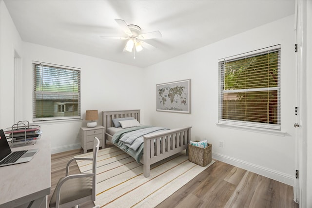 2207 English Dr, Garland, TX 75041 - bedroom with wood finished floors, a desk, and a ceiling fan