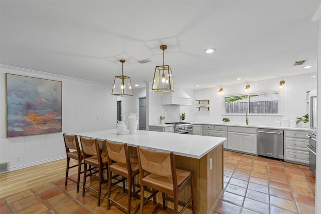 6805 Benito Ct, Fort Worth, TX 76126 - kitchen with appliances with stainless steel finishes, backsplash, light countertops, a breakfast bar, and hanging light fixtures