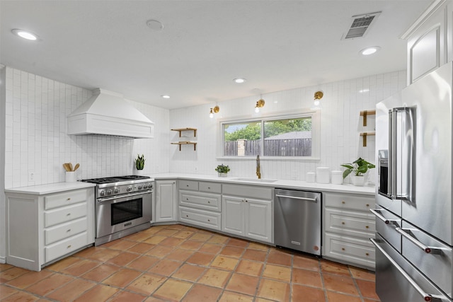 6805 Benito Ct, Fort Worth, TX 76126 - kitchen with high quality appliances, custom exhaust hood, tasteful backsplash, light countertops, and recessed lighting