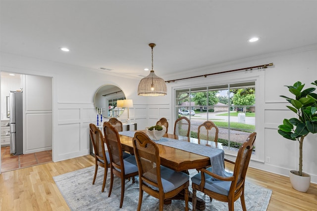 6805 Benito Ct, Fort Worth, TX 76126 - dining space featuring a decorative wall, ornamental molding, light wood-style floors, and recessed lighting