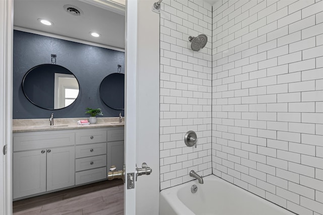 6805 Benito Ct, Fort Worth, TX 76126 - bathroom featuring  shower combination, double vanity, wood finished floors, a textured wall, and recessed lighting