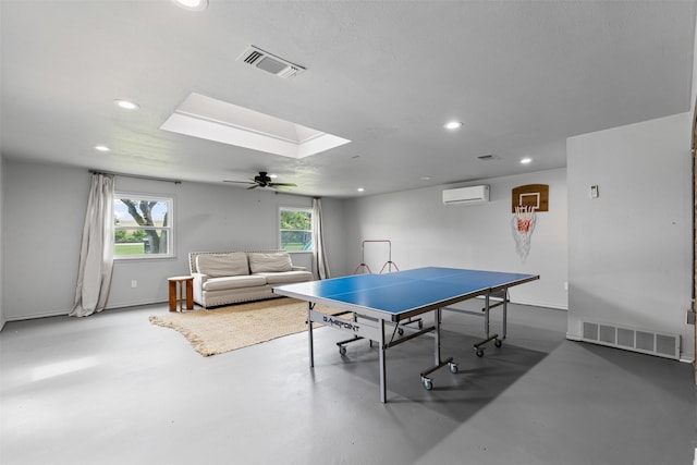 6805 Benito Ct, Fort Worth, TX 76126 - playroom featuring an AC wall unit, concrete floors, recessed lighting, plenty of natural light, and a skylight