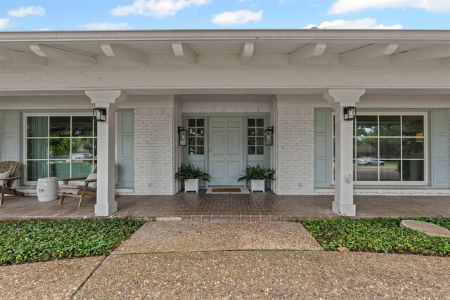 6805 Benito Ct, Fort Worth, TX 76126 - view of exterior entry featuring a porch and brick siding