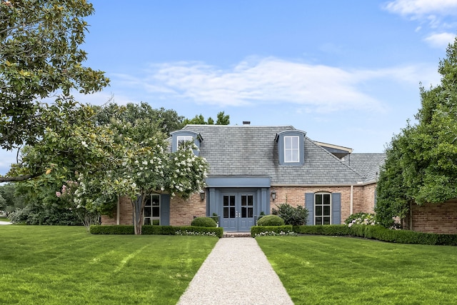 6710 Meadowcreek Dr, Dallas, TX 75254 - view of front of house featuring french doors, brick siding, and a front yard
