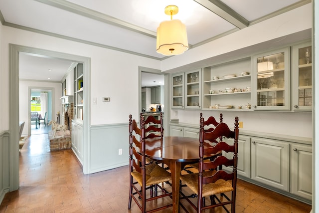 6710 Meadowcreek Dr, Dallas, TX 75254 - dining space featuring crown molding, a wainscoted wall, and brick patterned floors