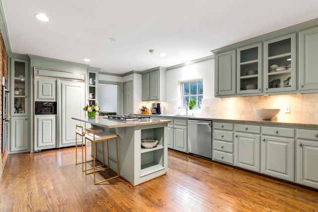 6710 Meadowcreek Dr, Dallas, TX 75254 - kitchen featuring stainless steel appliances, ornamental molding, open shelves, backsplash, and wood finished floors