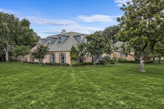 6710 Meadowcreek Dr, Dallas, TX 75254 - french provincial home featuring brick siding, a chimney, and a front yard