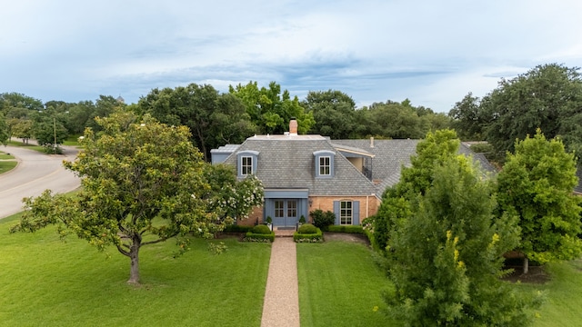 6710 Meadowcreek Dr, Dallas, TX 75254 - view of front of house featuring french doors, a front lawn, a chimney, brick siding, and view of scattered trees