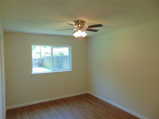 6207 Misty Wood Dr, Dallas, TX 75217 - spare room with wood finished floors, ceiling fan, and a textured ceiling