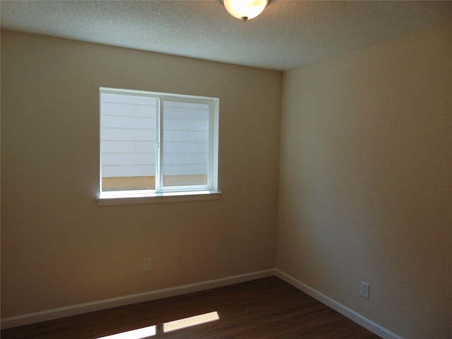 6207 Misty Wood Dr, Dallas, TX 75217 - unfurnished room featuring dark wood-type flooring and a textured ceiling