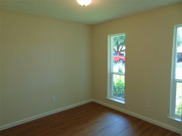 6207 Misty Wood Dr, Dallas, TX 75217 - spare room featuring dark wood finished floors and baseboards