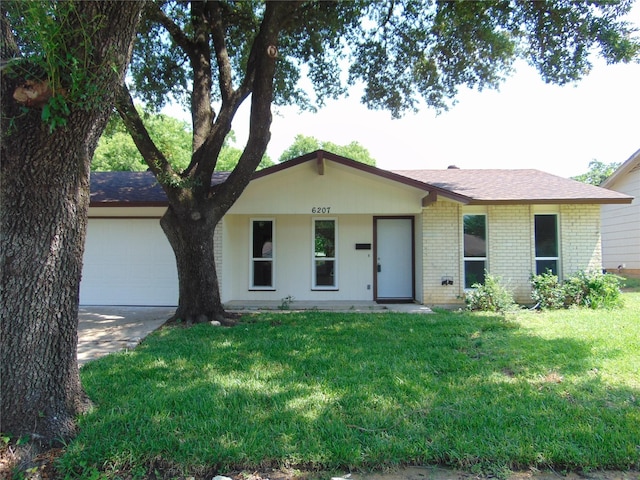 6207 Misty Wood Dr, Dallas, TX 75217 - ranch-style house featuring an attached garage, driveway, brick siding, and a front yard
