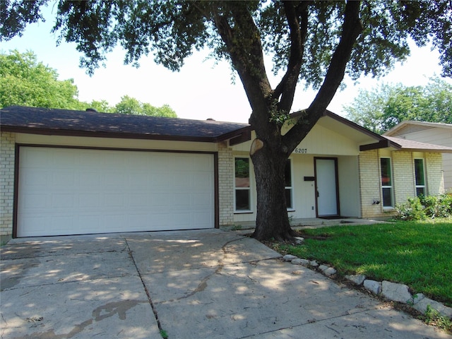 6207 Misty Wood Dr, Dallas, TX 75217 - ranch-style house featuring brick siding, driveway, a garage, and a front yard