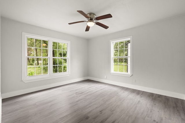 3624 Baylor St, Fort Worth, TX 76119 - empty room featuring plenty of natural light, wood finished floors, and a ceiling fan