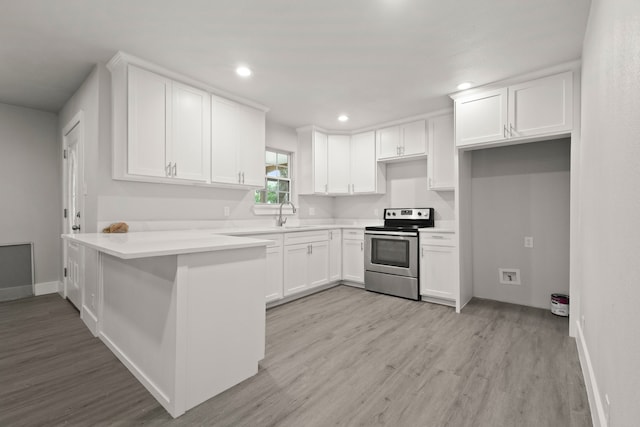 3624 Baylor St, Fort Worth, TX 76119 - kitchen featuring electric range, a peninsula, light wood-type flooring, white cabinets, and recessed lighting