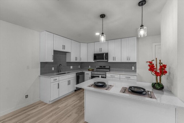 7302 Vista Cliff Dr, Fort Worth, TX 76179 - kitchen with appliances with stainless steel finishes, tasteful backsplash, white cabinetry, and light wood finished floors
