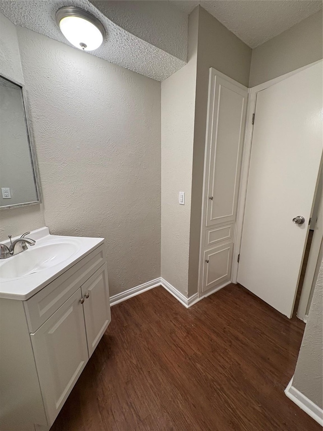 2209 Viewtop Ln Unit 2, Arlington, TX 76012 - bathroom featuring wood finished floors, vanity, a textured ceiling, and a textured wall